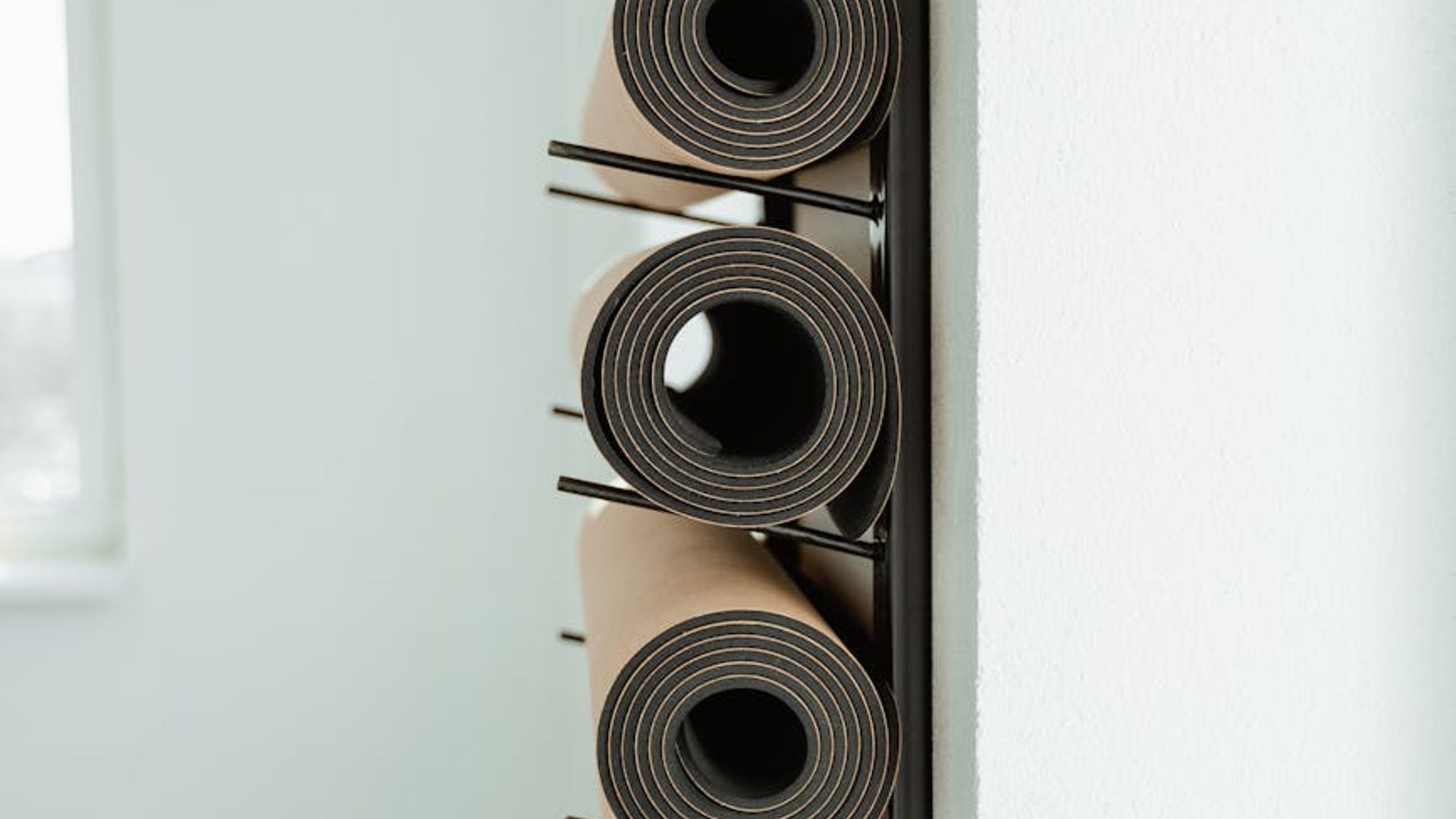 Minimalist yoga studio interior with soft lighting and mats.